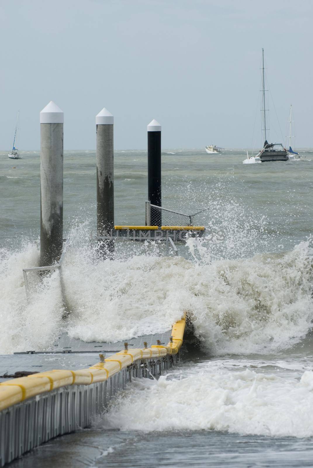 storm force winds and waves wrecking a floating pontoon jetty