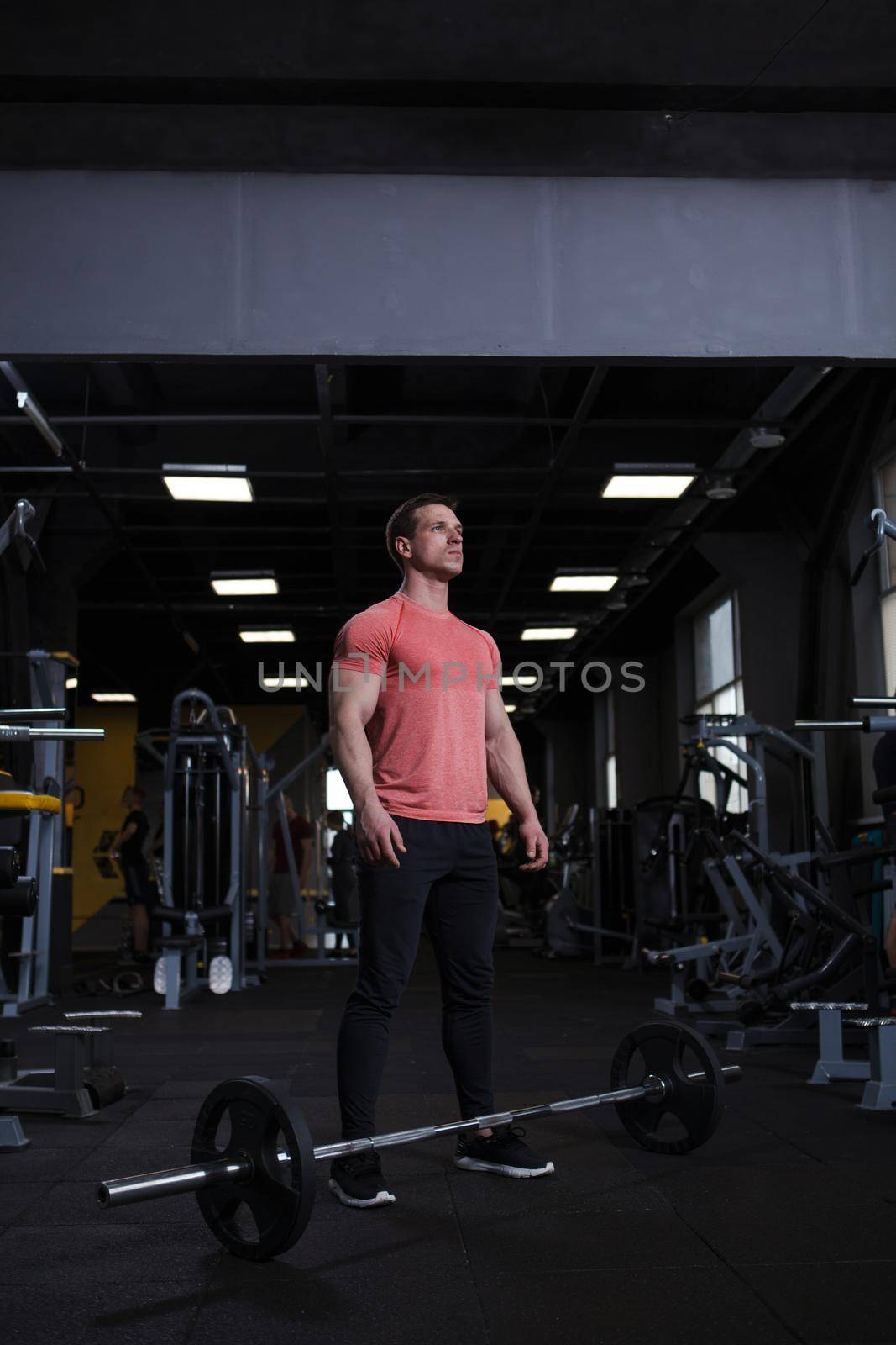 Vertical shot of a strong confident male athlete preparing for barbell workout