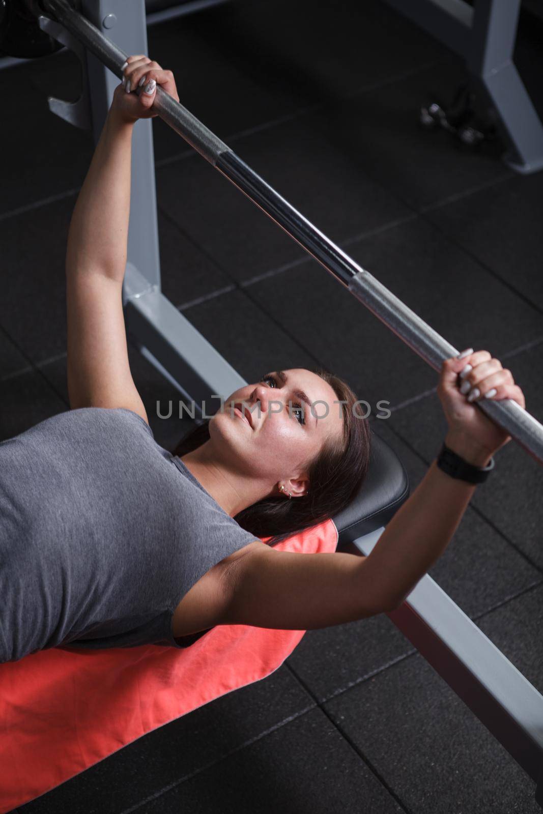 Athletic woman working out at gym by MAD_Production