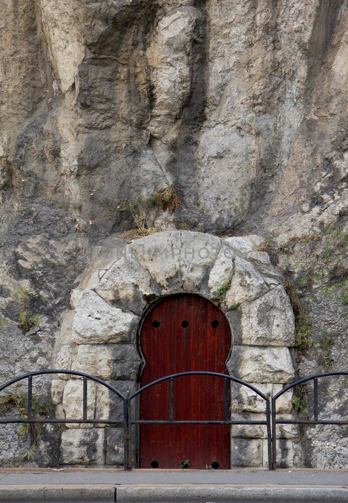 Vaulted entrance with a rock wall on the side of Gellert Hill. Budapest, Hungary