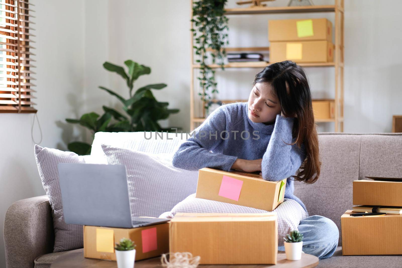 Young Asian Woman Working at home, Young Owner Woman annoyed customer and working with boring emotion. People with online shopping SME entrepreneur or freelance working concept..