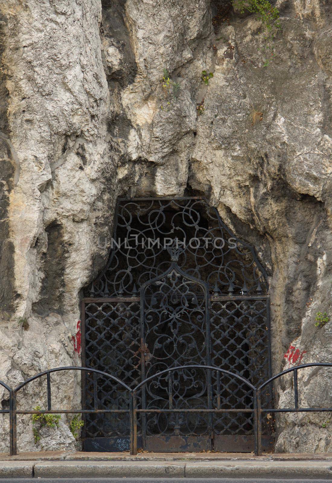 Vaulted entrance with a rock wall on the side of Gellert Hill. Budapest, Hungary