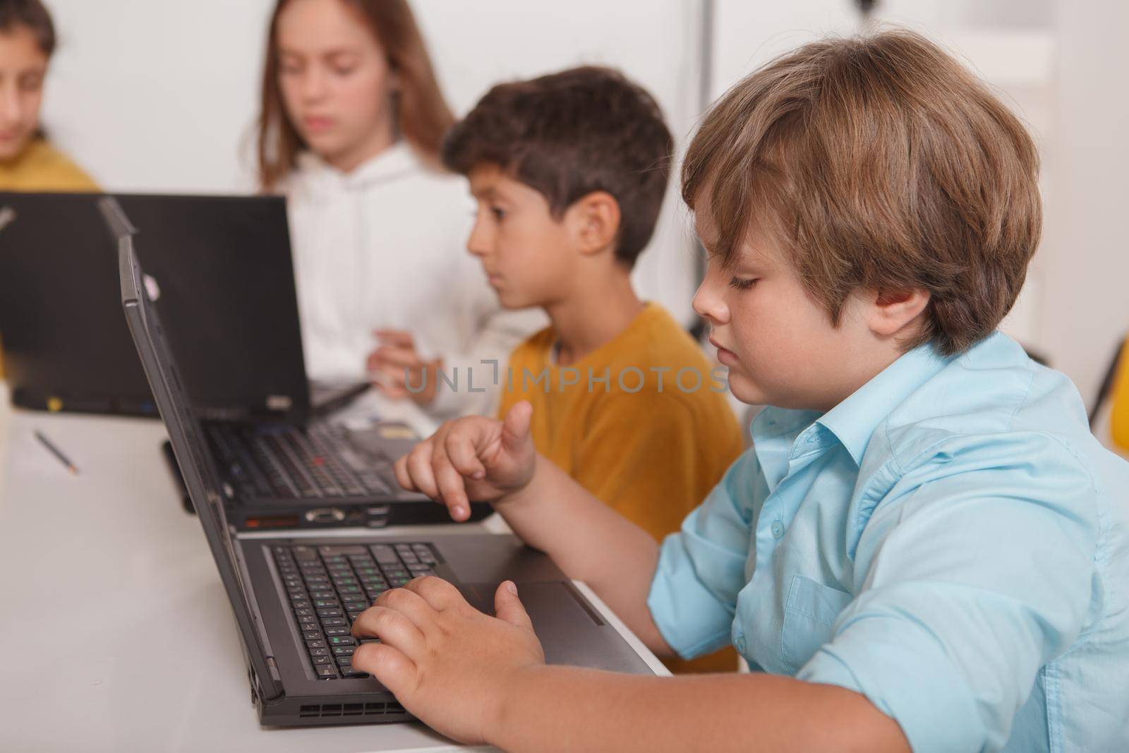 Kids working on laptop at computer school, copy space