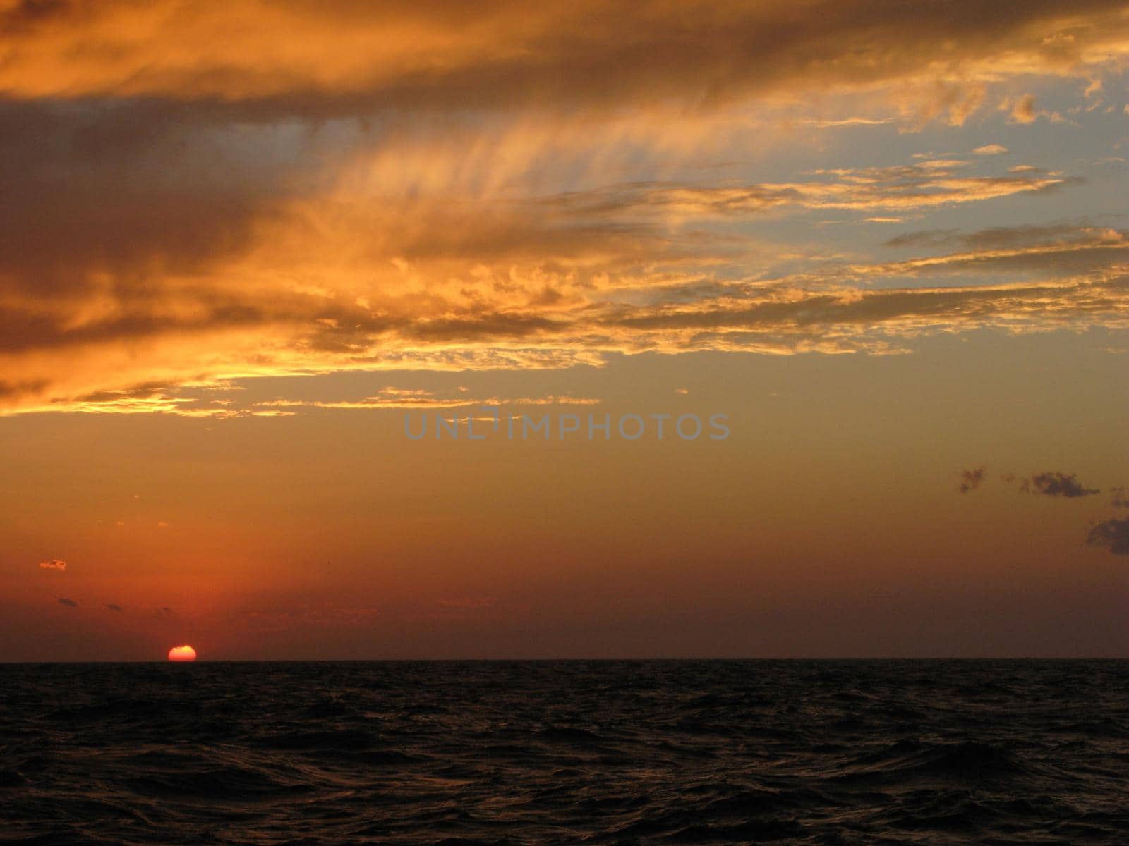 a sunset lilluminating the sky golden orange in color