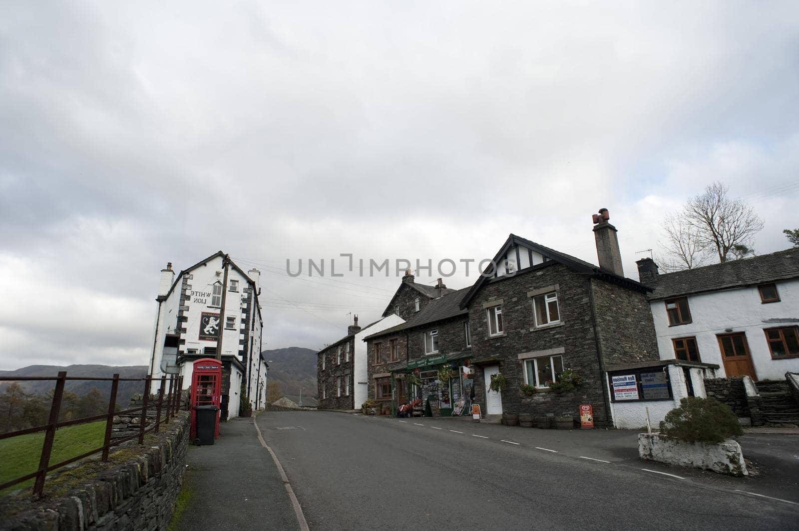 Quaint historical local English pub in a rural village street surrounded by lush countryside and hills for a relaxing venue for an evening drink or midday meal