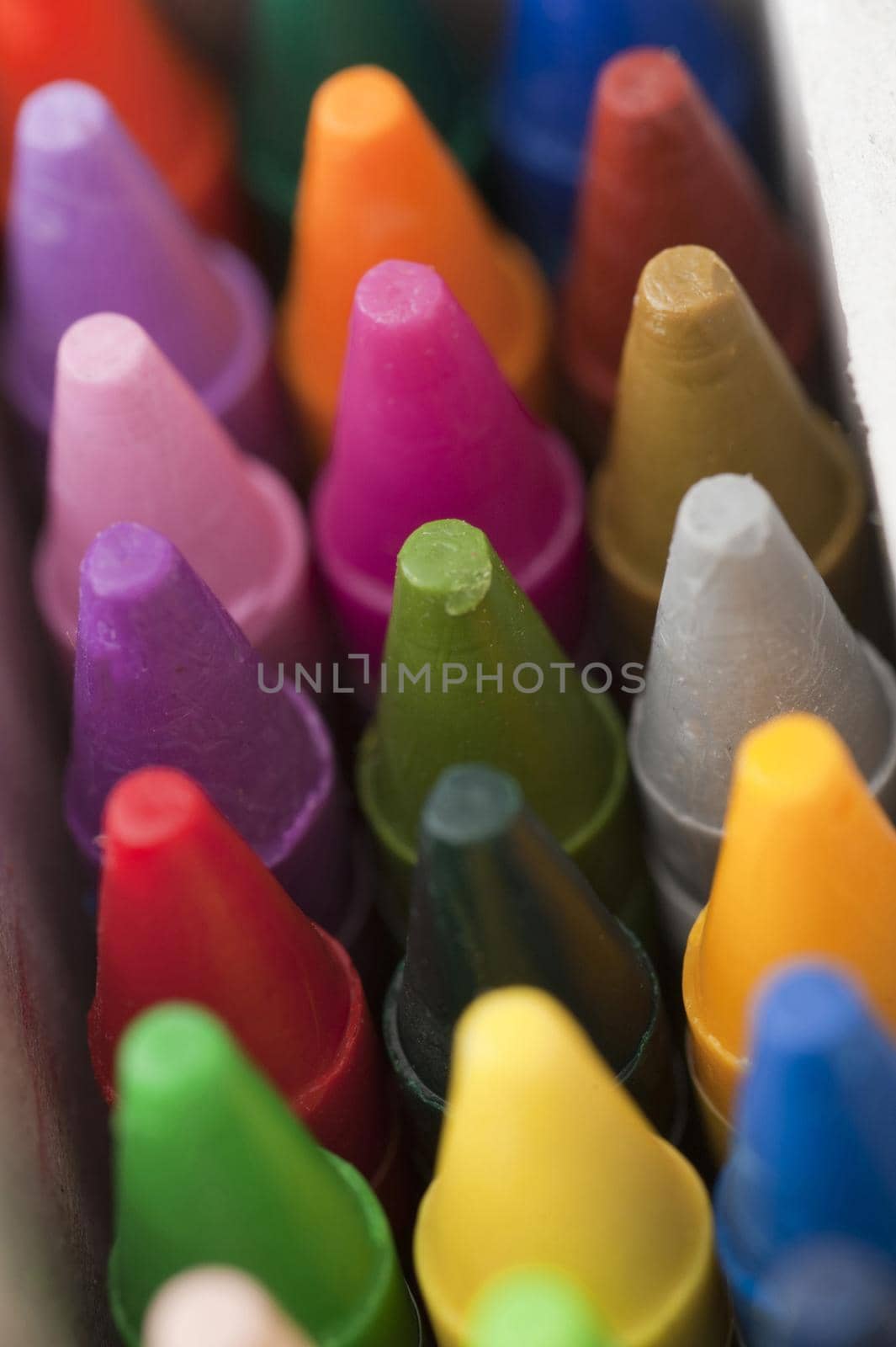 Close up top view of new crayon tips close together and pointing up
