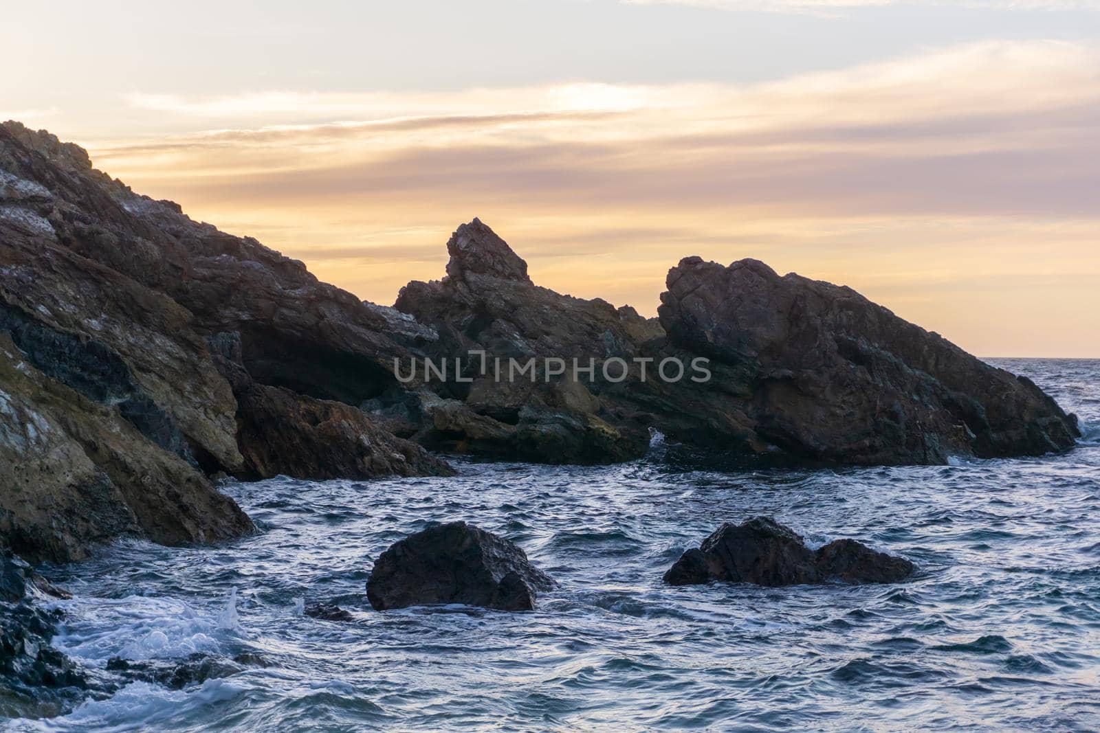 Rocks on the coast of the Atlantic Ocean in the evening after sunset. Ocean landscape