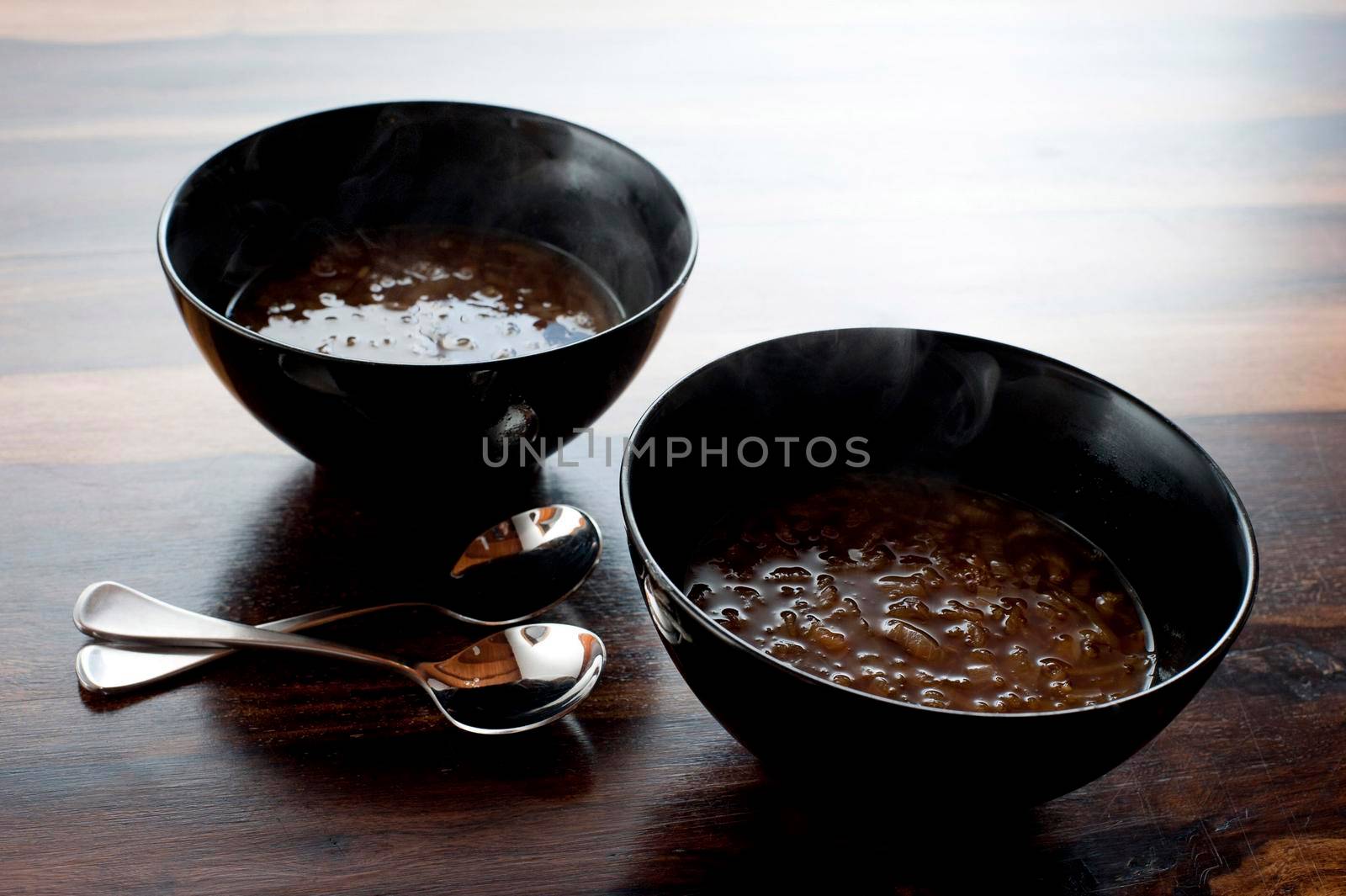 Delicious bowl of French onion soup full of chopped onion served as a starter , high angle view