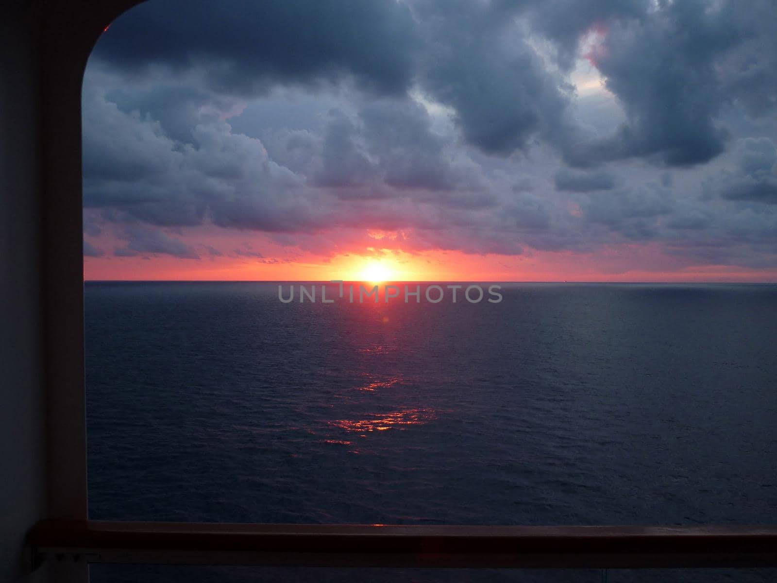 looking out at the setting sun from a cruise ship
