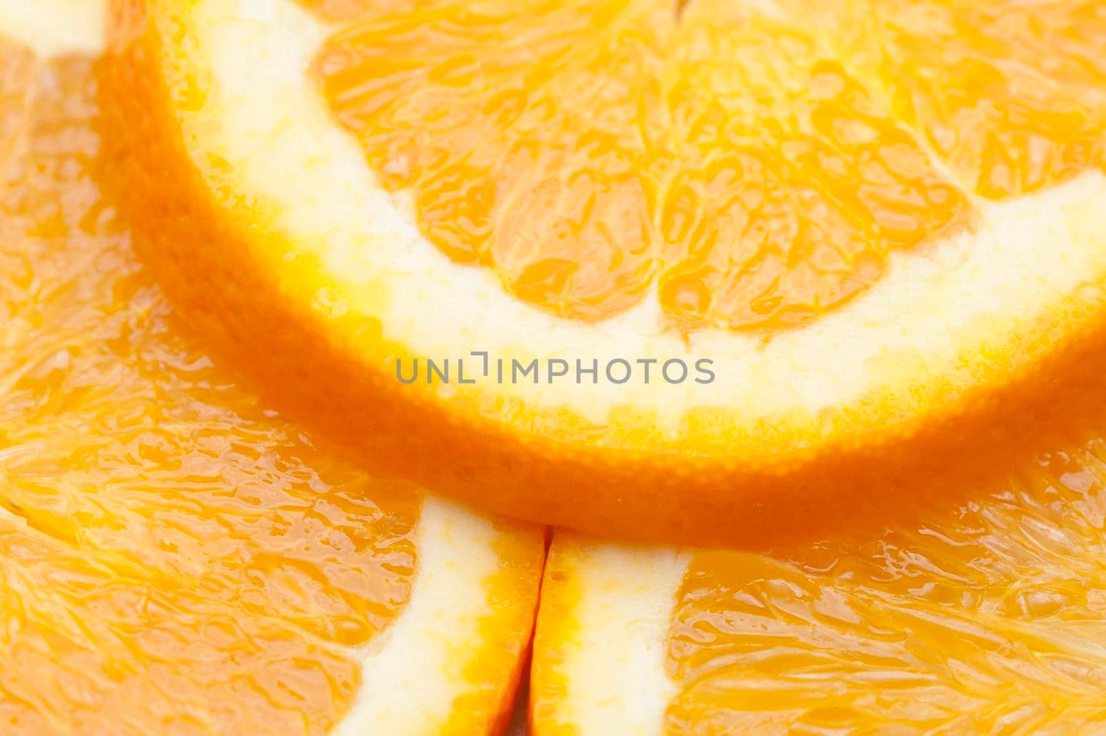 Fresh orange slices showing detail of the juicy pulp and rind prepared as a colourful garnish or salad ingredient