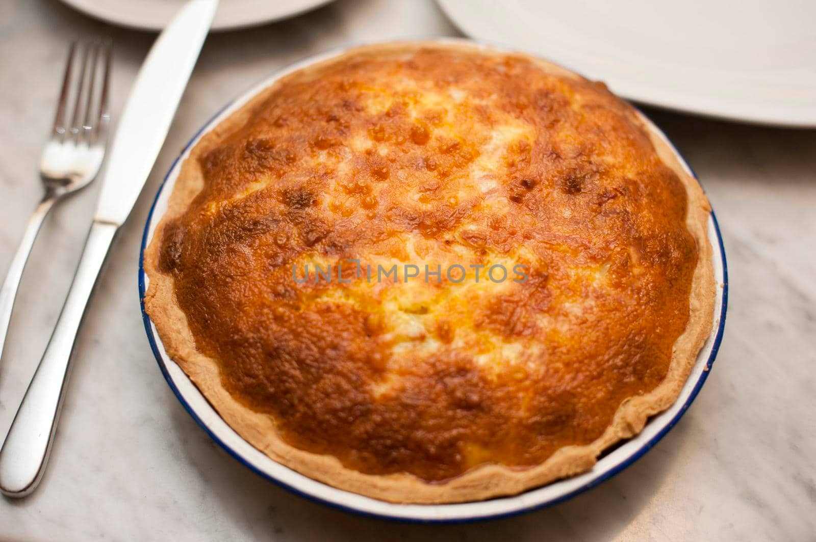 Delicious golden freshly baked uncut pie on a dinner table waiting to be carved and served