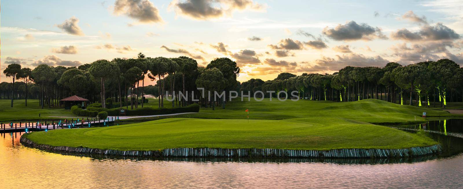 Golf course panorama at dramatic sunset with beautiful sky