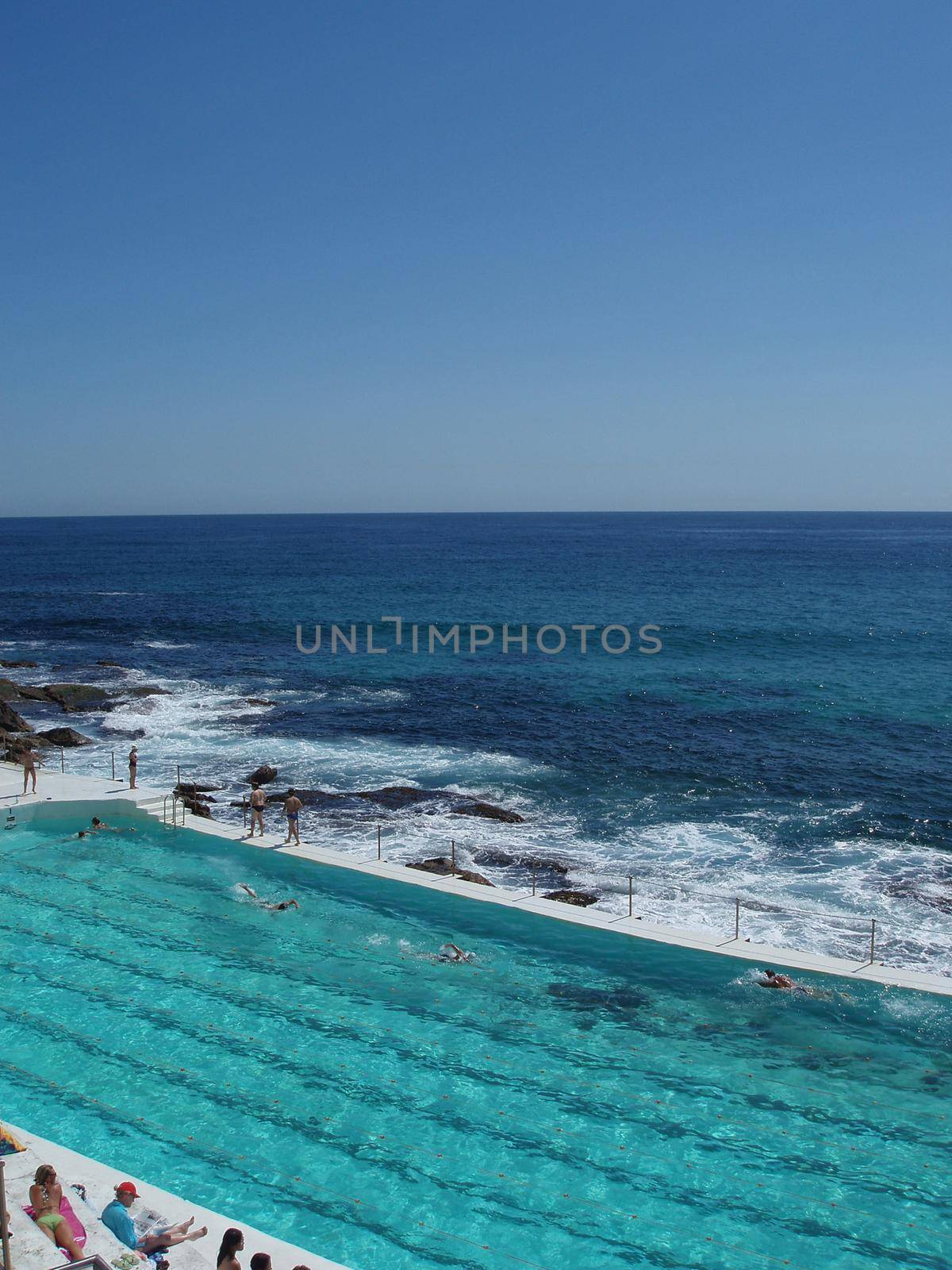 an outdoor swimming pool on a sunny summer day      