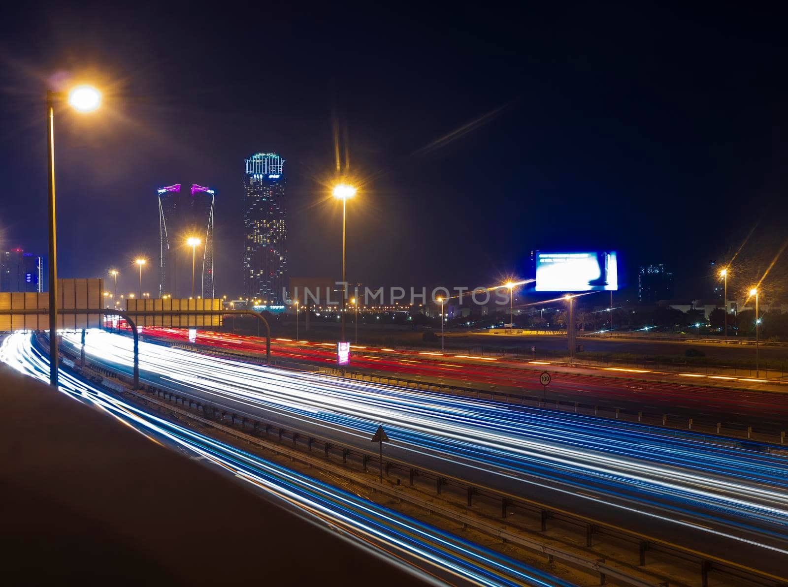 Dubai, UAE - 06.04.2021 Light trails on Al Khail road at night. Urban by pazemin