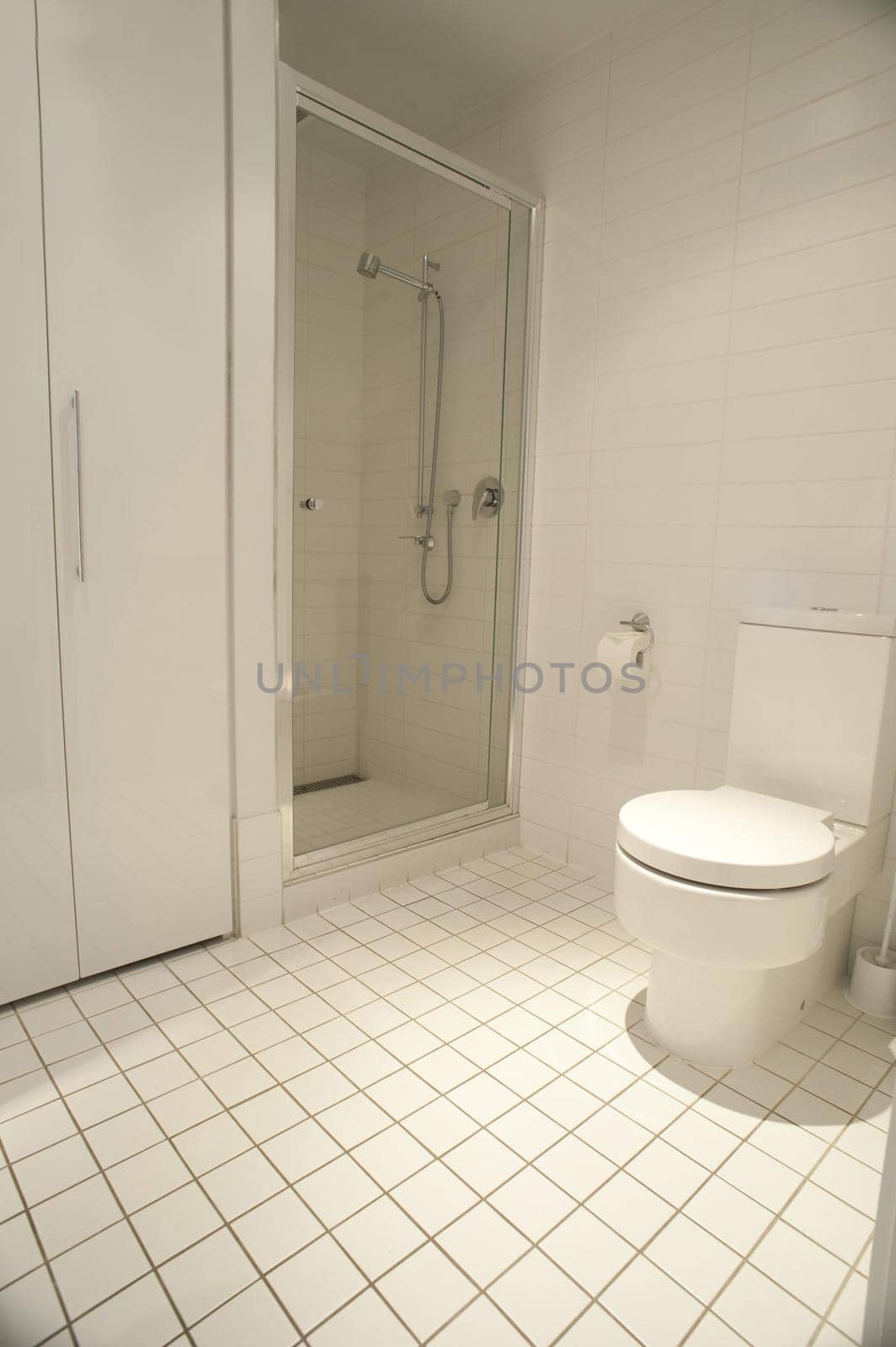 Close up Modern White Architectural Spacious Home Bathroom Design with Tiled Floor.