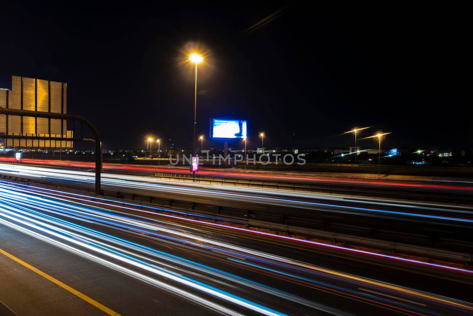 Dubai, UAE - 06.04.2021 Light trails on Al Khail road at night. Urban by pazemin