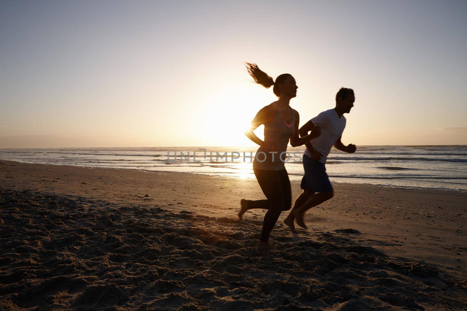 Motivating each other to run. a young couple exercising outdoors