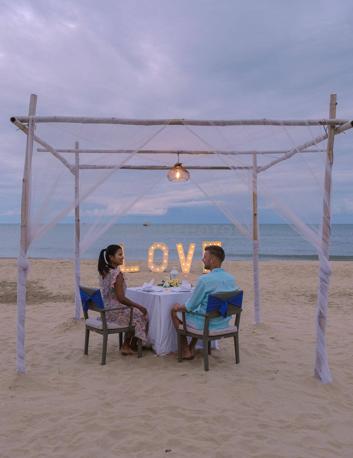 Romantic dinner on the beach of Huahin Thailand, dinner by candlelight in Hua Hin, Valentine's concept. Couple of men and women having a romantic dinner on the beach in Thailand