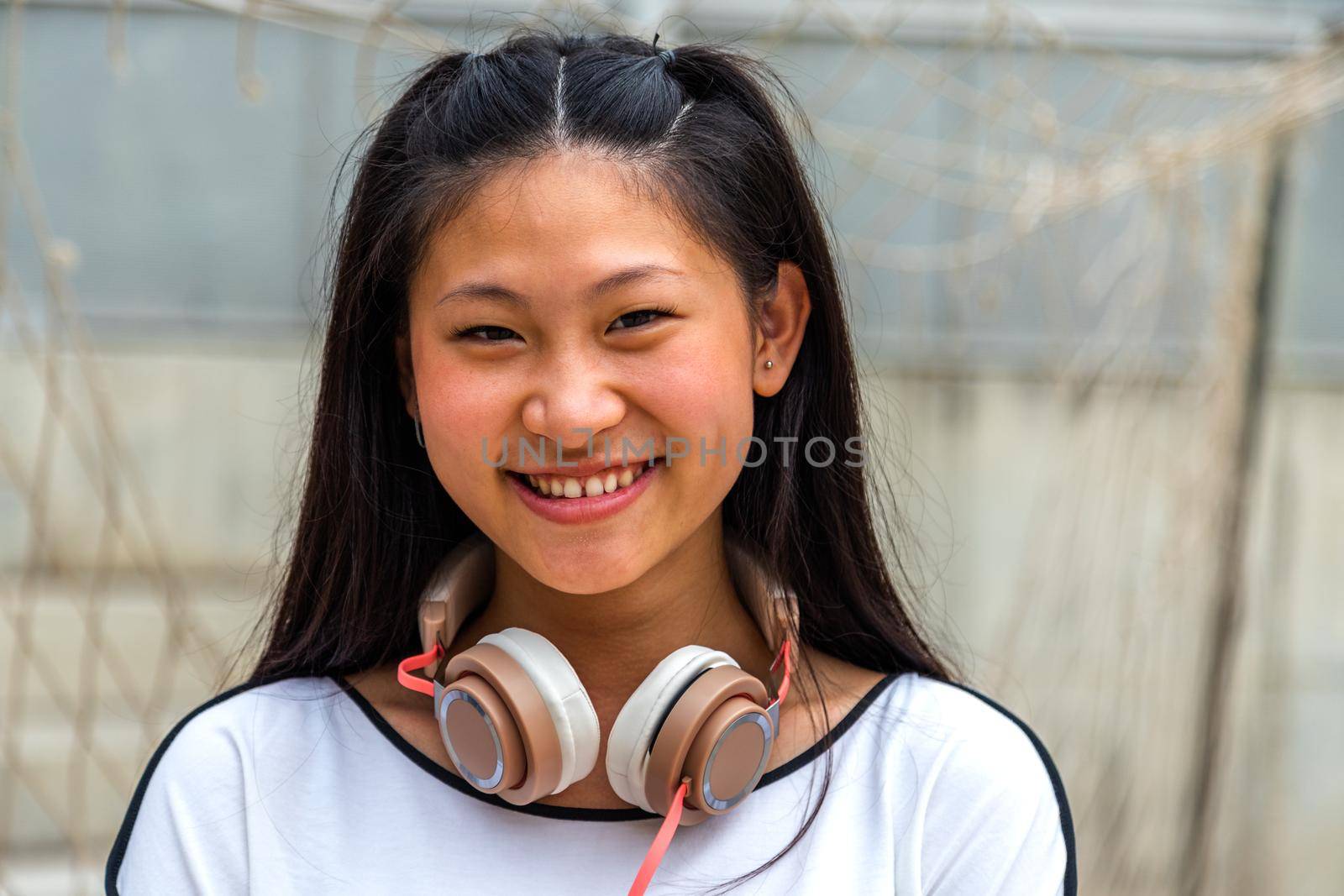 Portrait of happy and smiling asian teen girl looking at camera. Headshot.