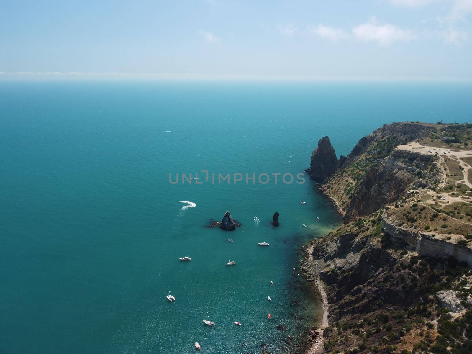 Aerial boat race. Luxury cruise trip. View from above of white boat on deep blue water. Aerial view of rich yacht sailing sea. Motor boat racing wave. Summer journey on luxury ship