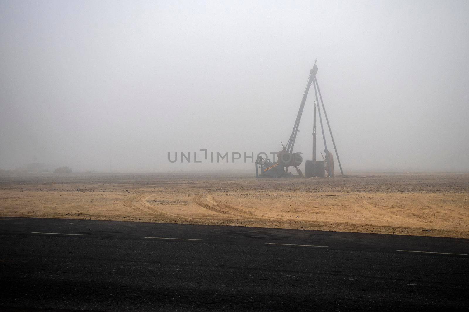 Men working on foggy morning.