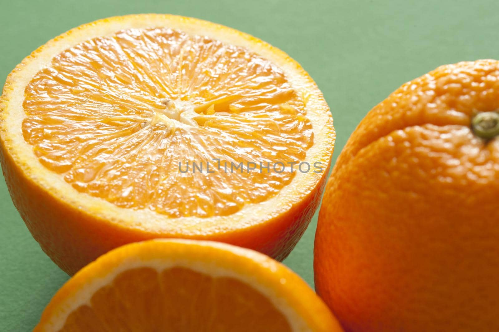 Close-up of half of orange on green background