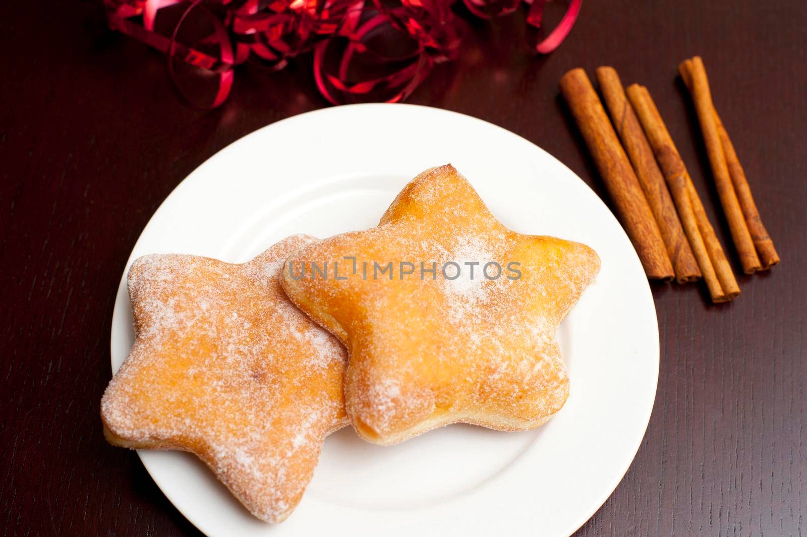 Star shaped sugared doughnuts on a plate for a festive seasonal Christmas dessert or snack