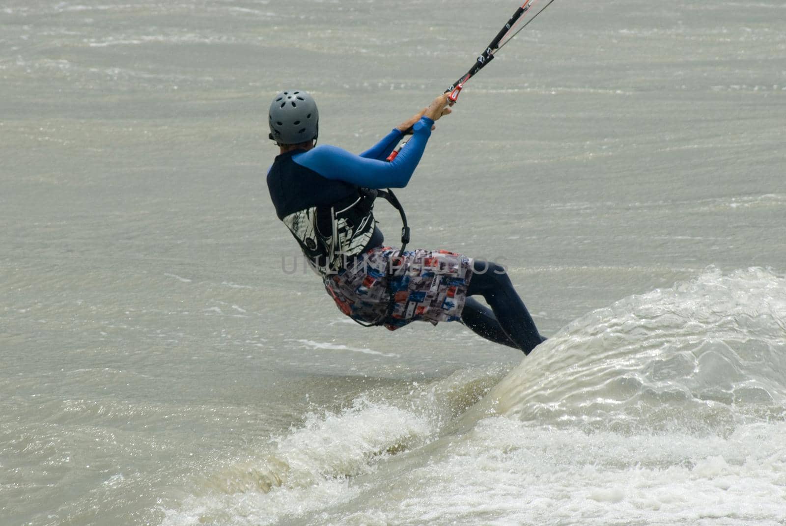 a kitesurfer screaming through the water
