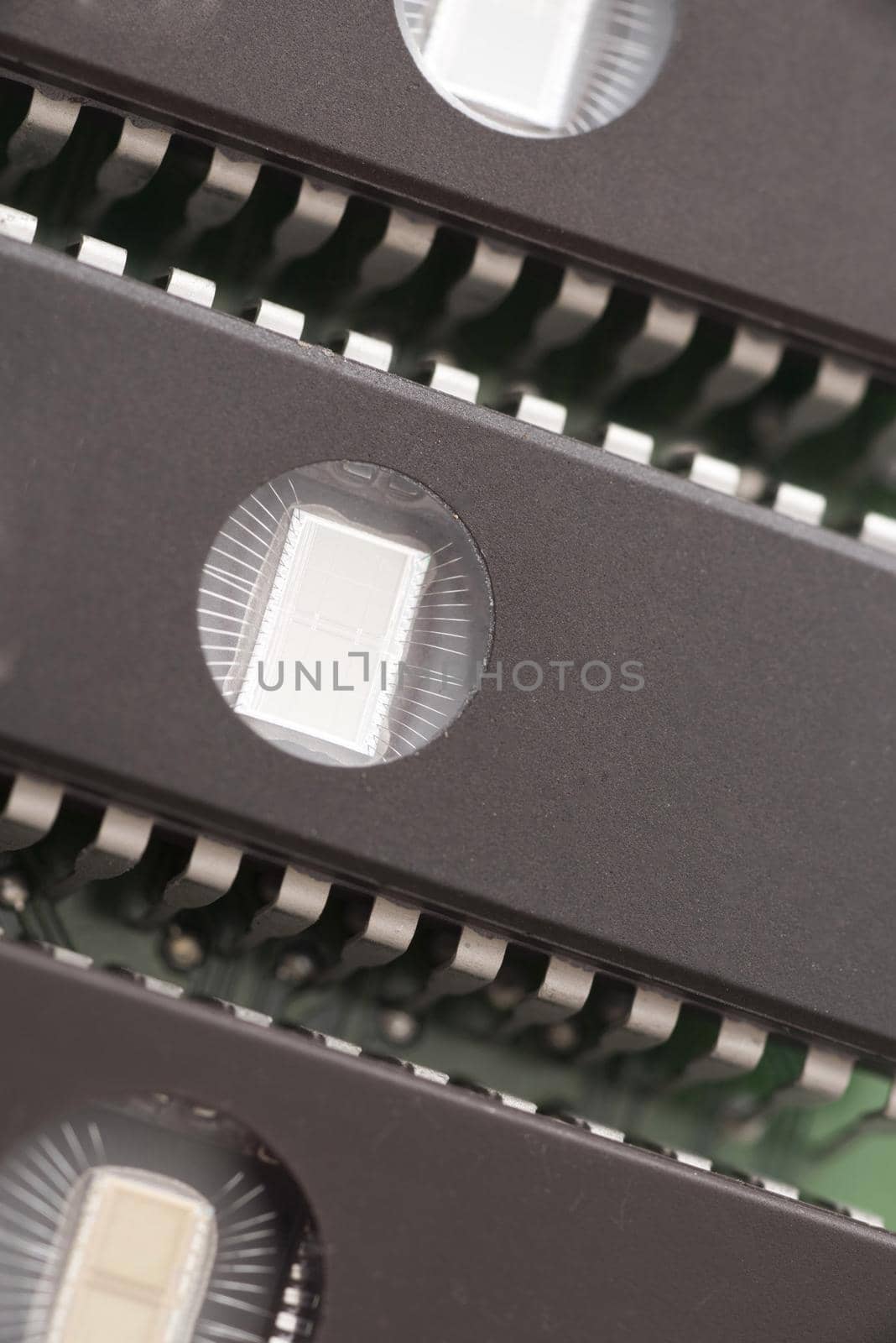 Close up of three memory chips, lined up side by side as components on a computer motherboard.