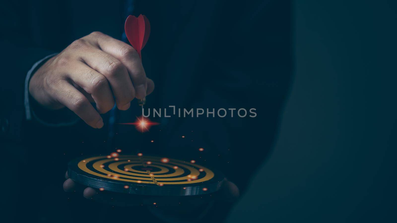 Businessman hand holding red dart to the virtual target dartboard marketing strategy goal and target for business investment concept.