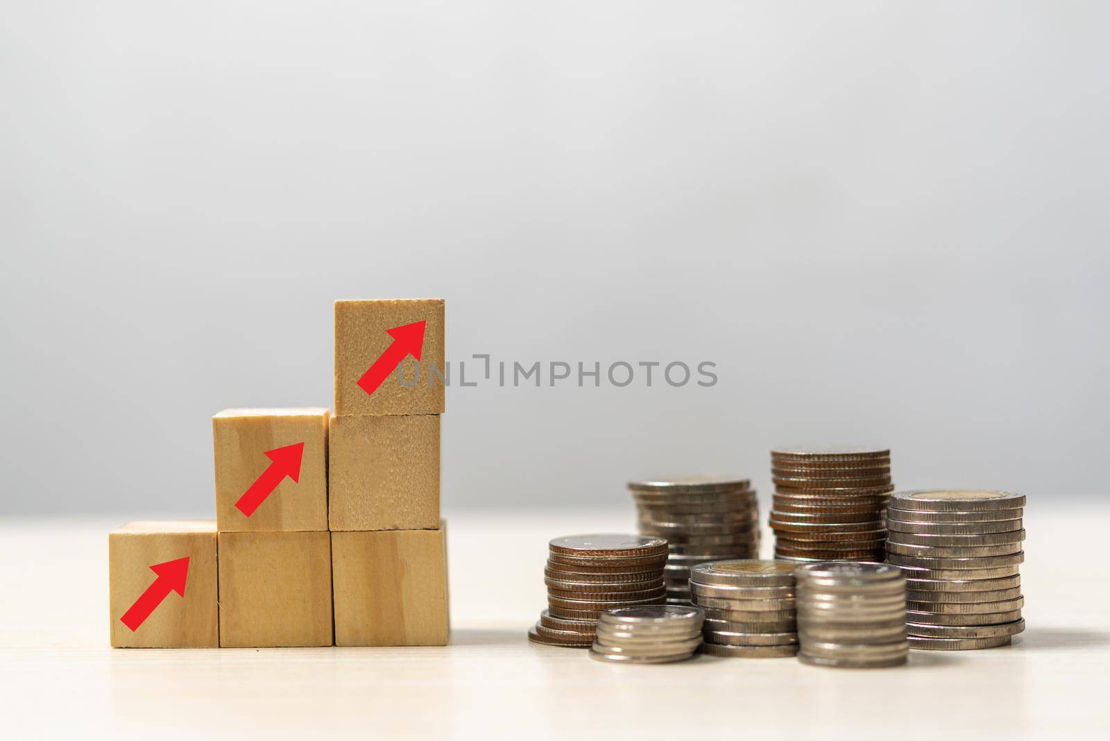 Business finance investments economy stack coin inflation and arrow red with wood cube on desk. by aoo3771