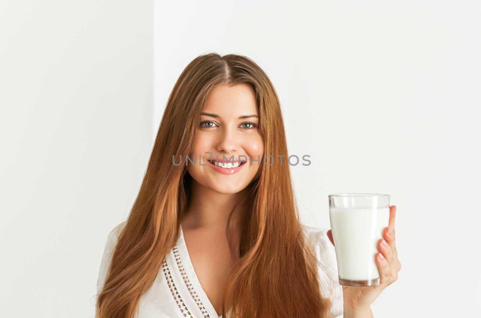 Diet, health and wellness concept, woman holding glass of milk or protein shake cocktail