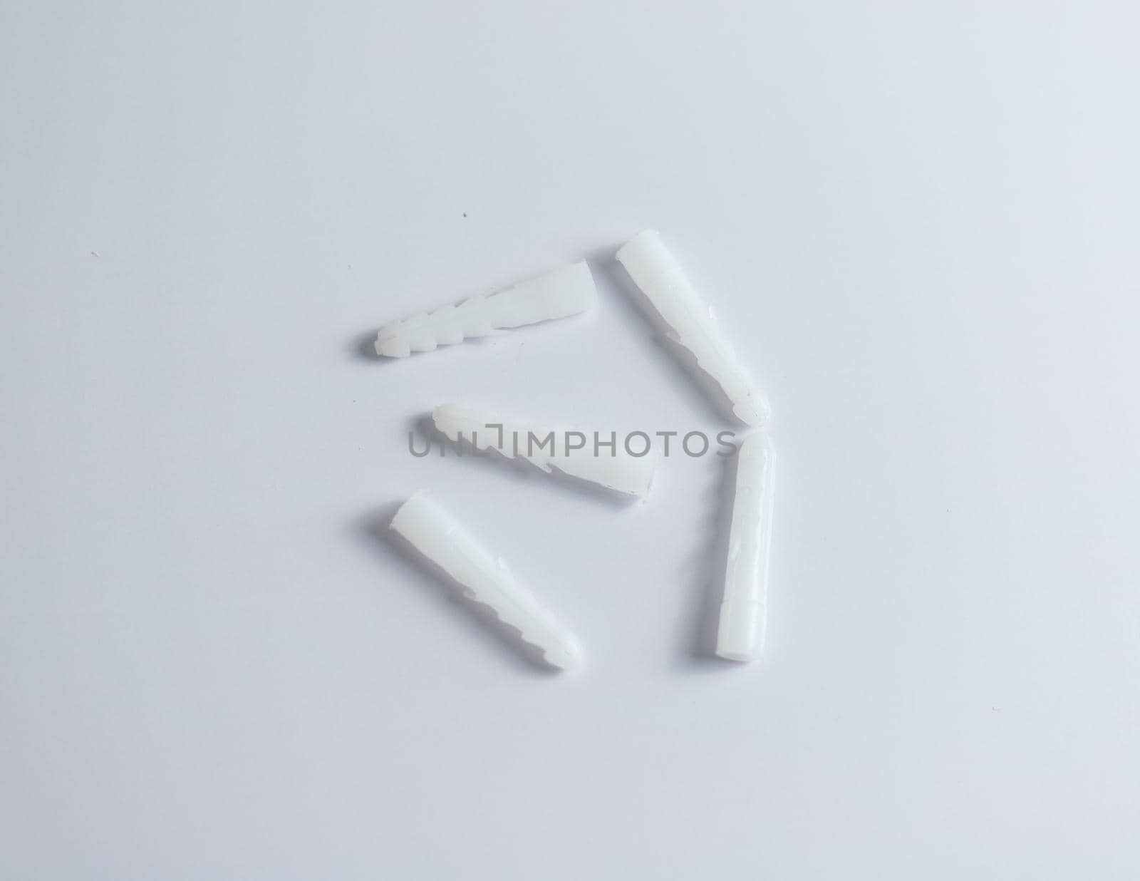 White plastic dowels on isolated white background