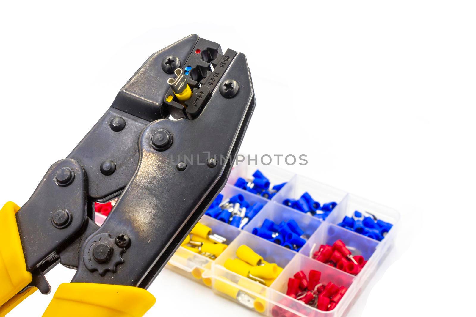 crimping isolated connectors with a old yellow tool on white background 