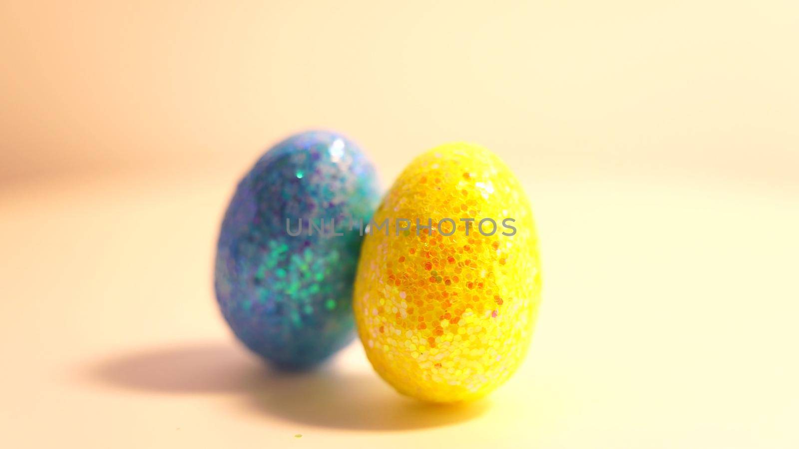 Colorful Easter eggs rotating in rows in a seamless loop on a light background.