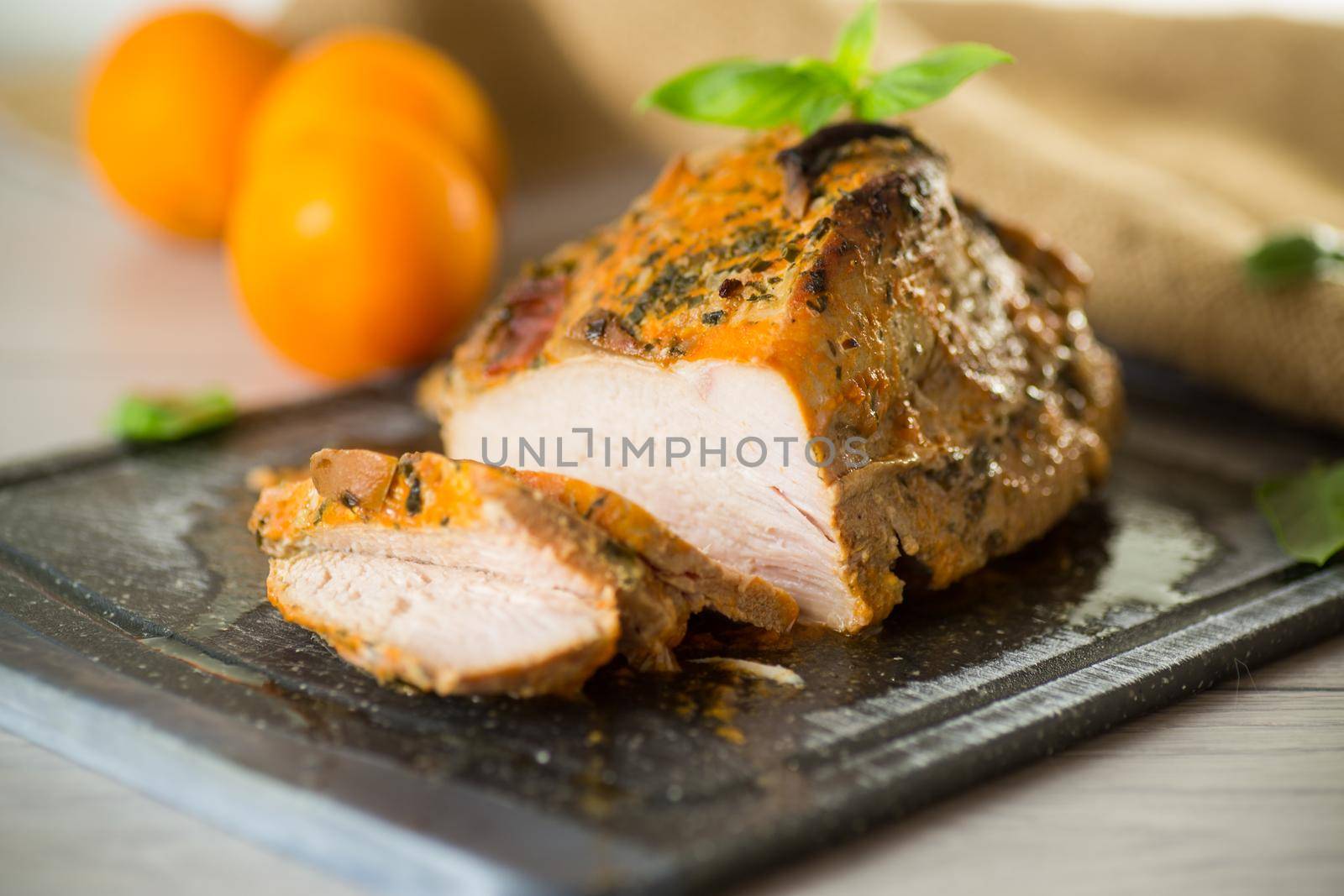 Baked sirloin turkey meat homemade with spices, on a wooden table.