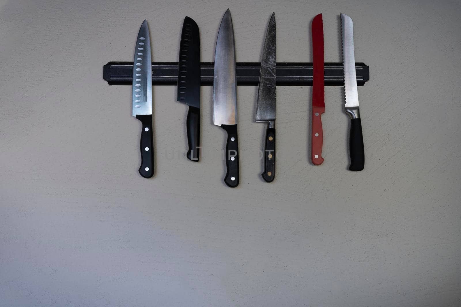 Top view of sharp knife placed on cutting board with sharp knife on gray background