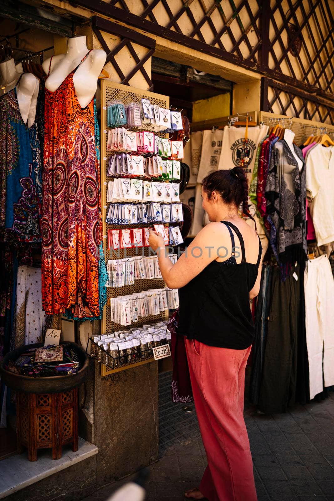 Woman buying souvenirs at the street market by barcielaphoto