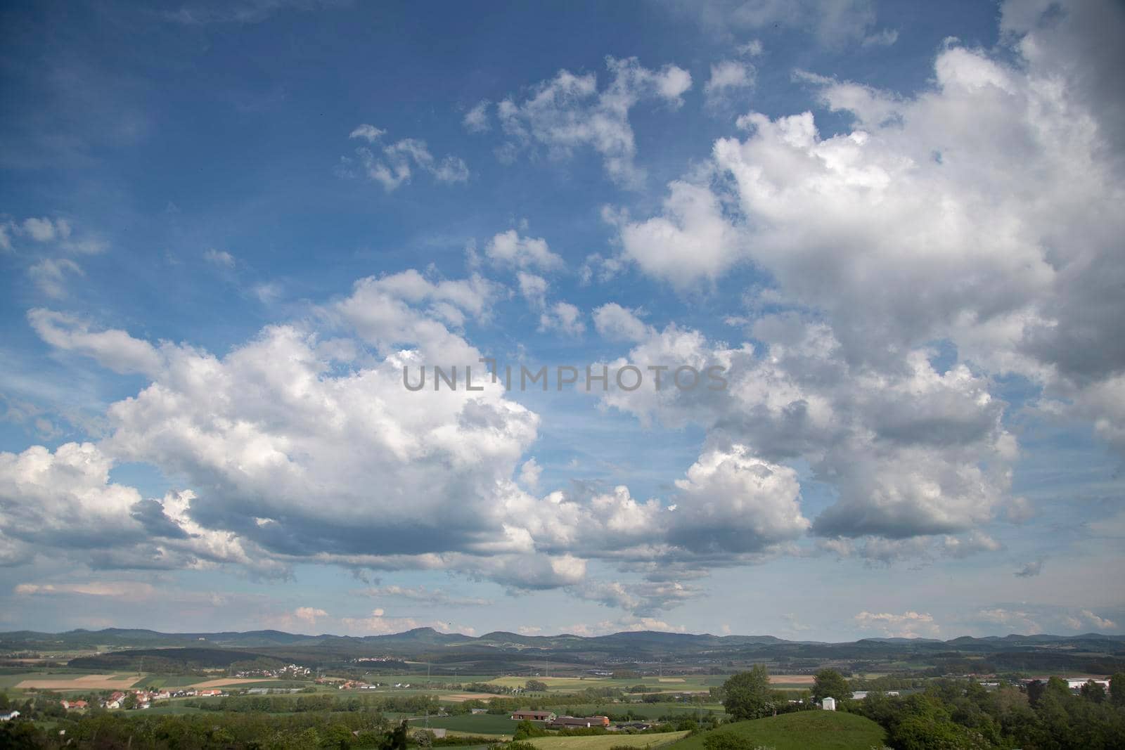 Beauty cloud against a blue sky background. Sky slouds. Blue sky with cloudy weather, nature cloud over the landskape. Over the land white clouds, blue sky and sun. by Costin