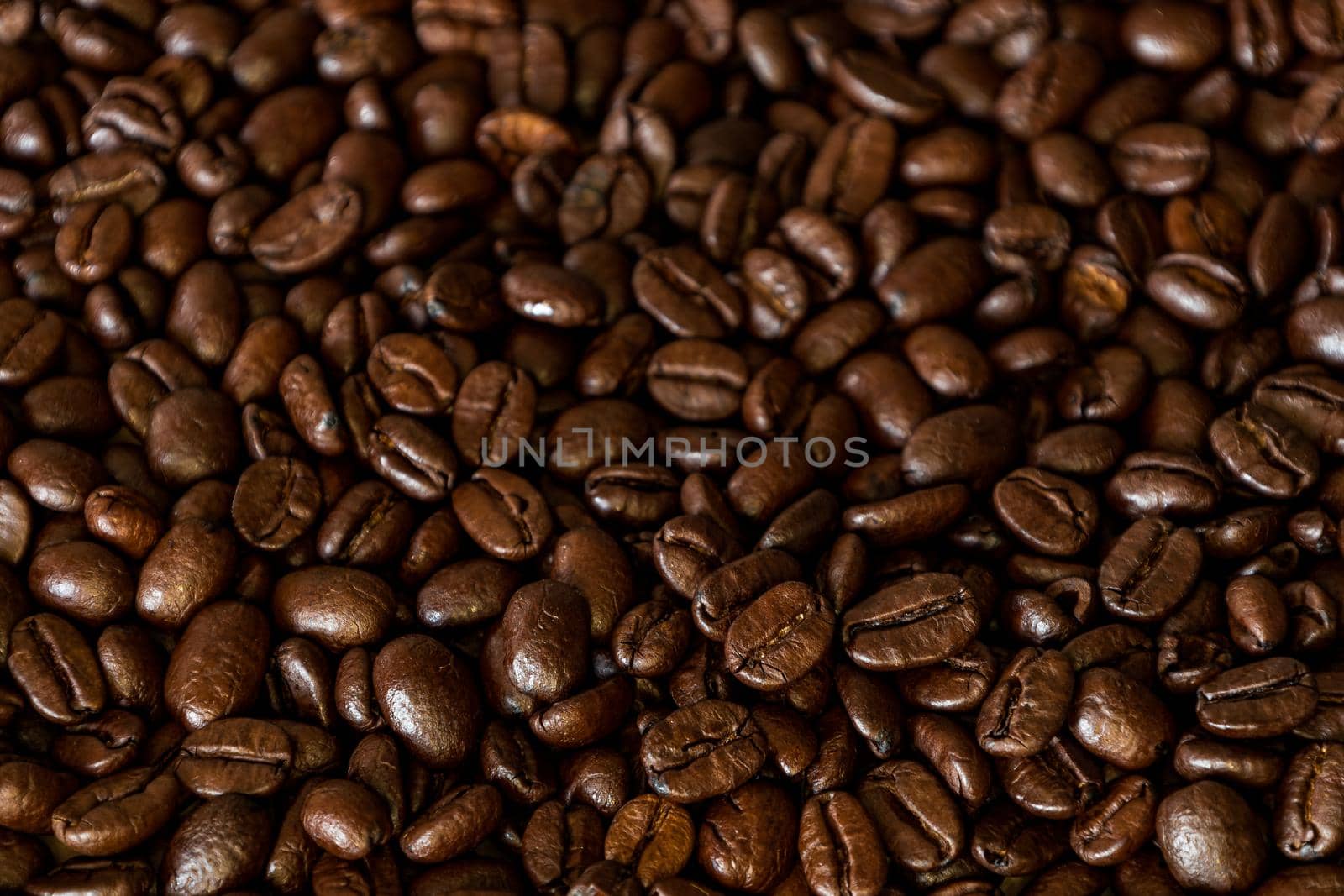Brown Roasted Coffee Beans Closeup On Dark Background. High quality photo
