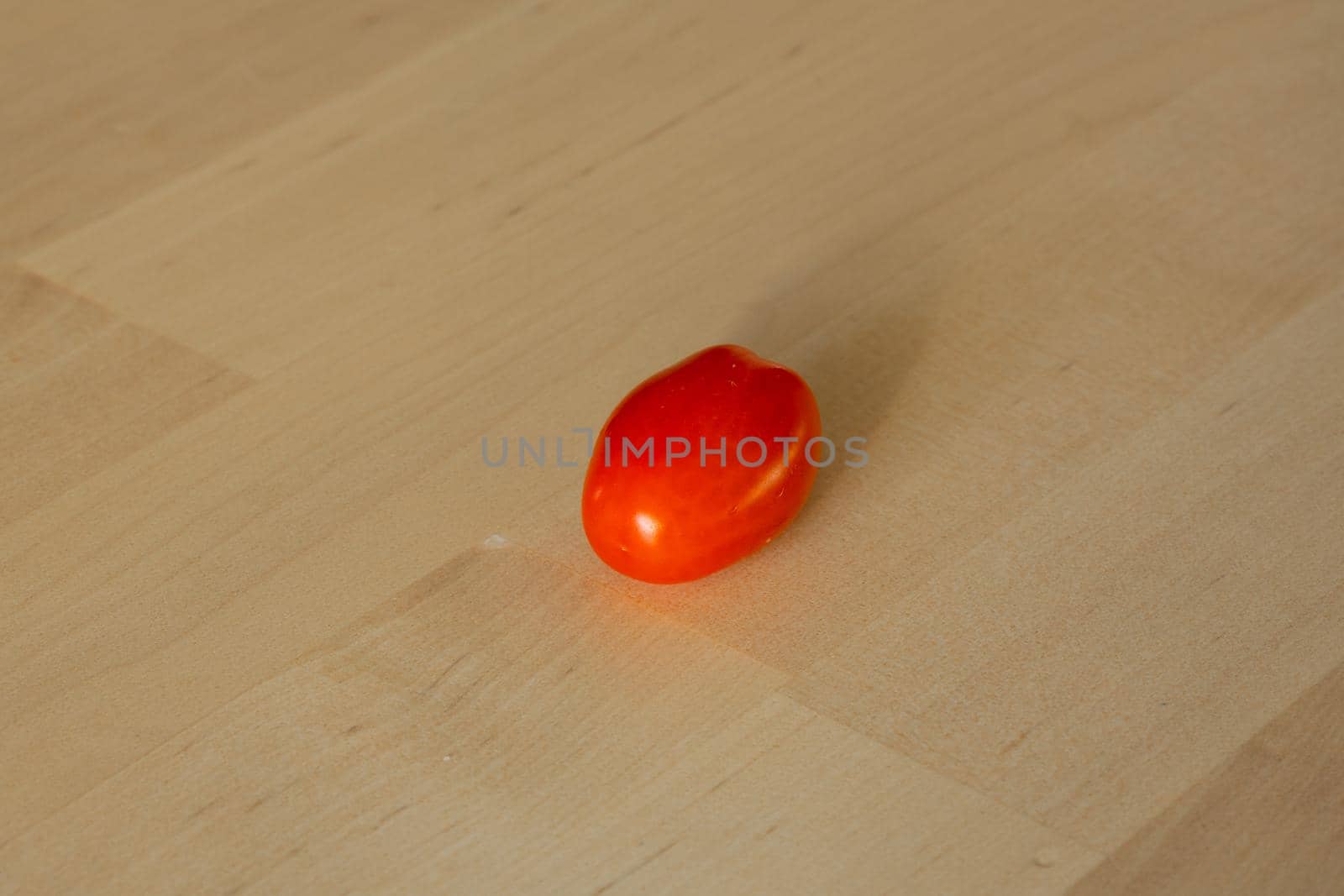 Fresh cherry tomato isolated on wooden background. High quality photo