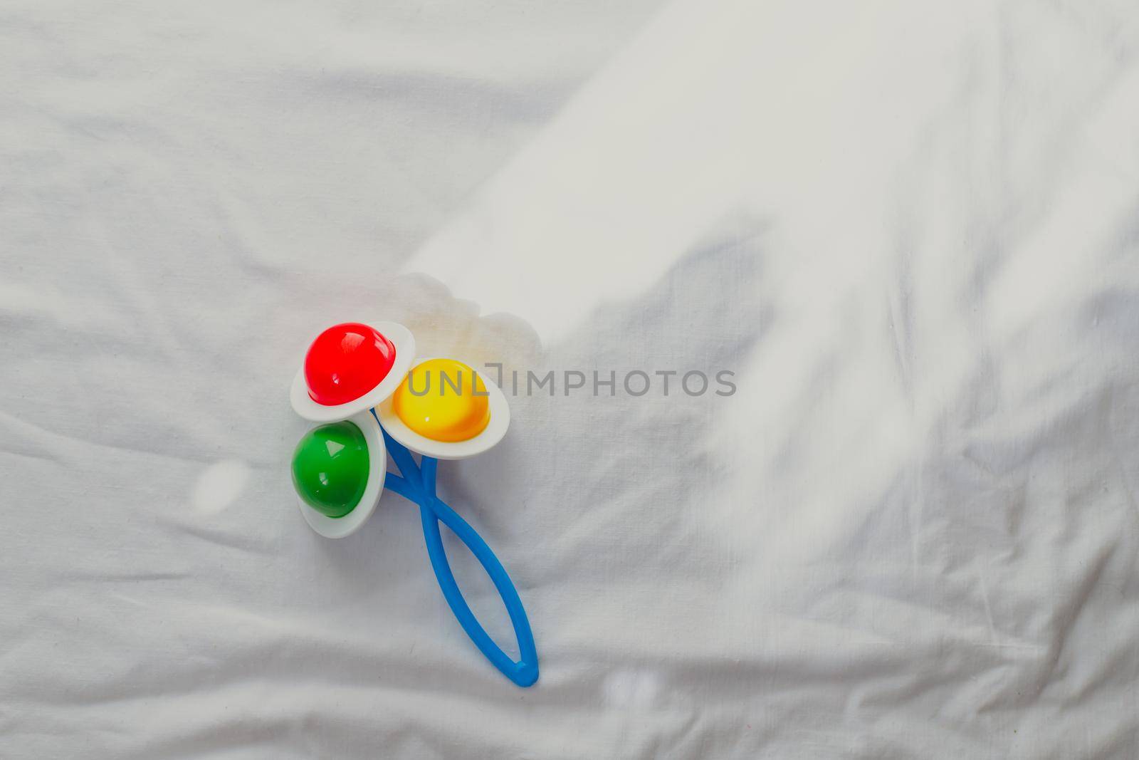 Baby rattle on a white background copyspace. Educational toys for kids. Toy copyspace . by alenka2194