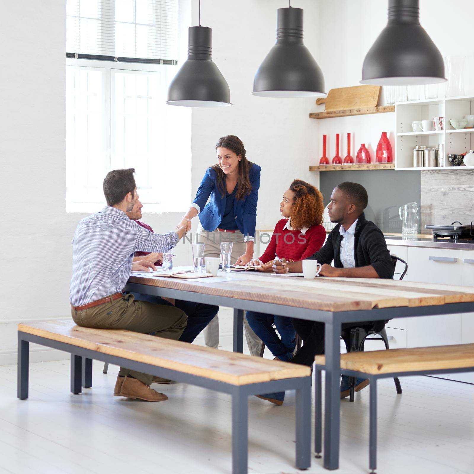 Welcome to the team. Full length shot of a young businesswoman shaking a colleagues hand during a business meeting