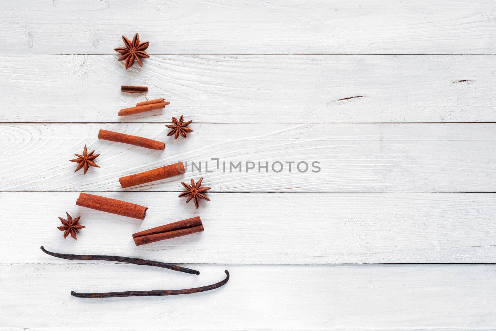 Christmas tree made of spices, white wooden background, top view, copy space