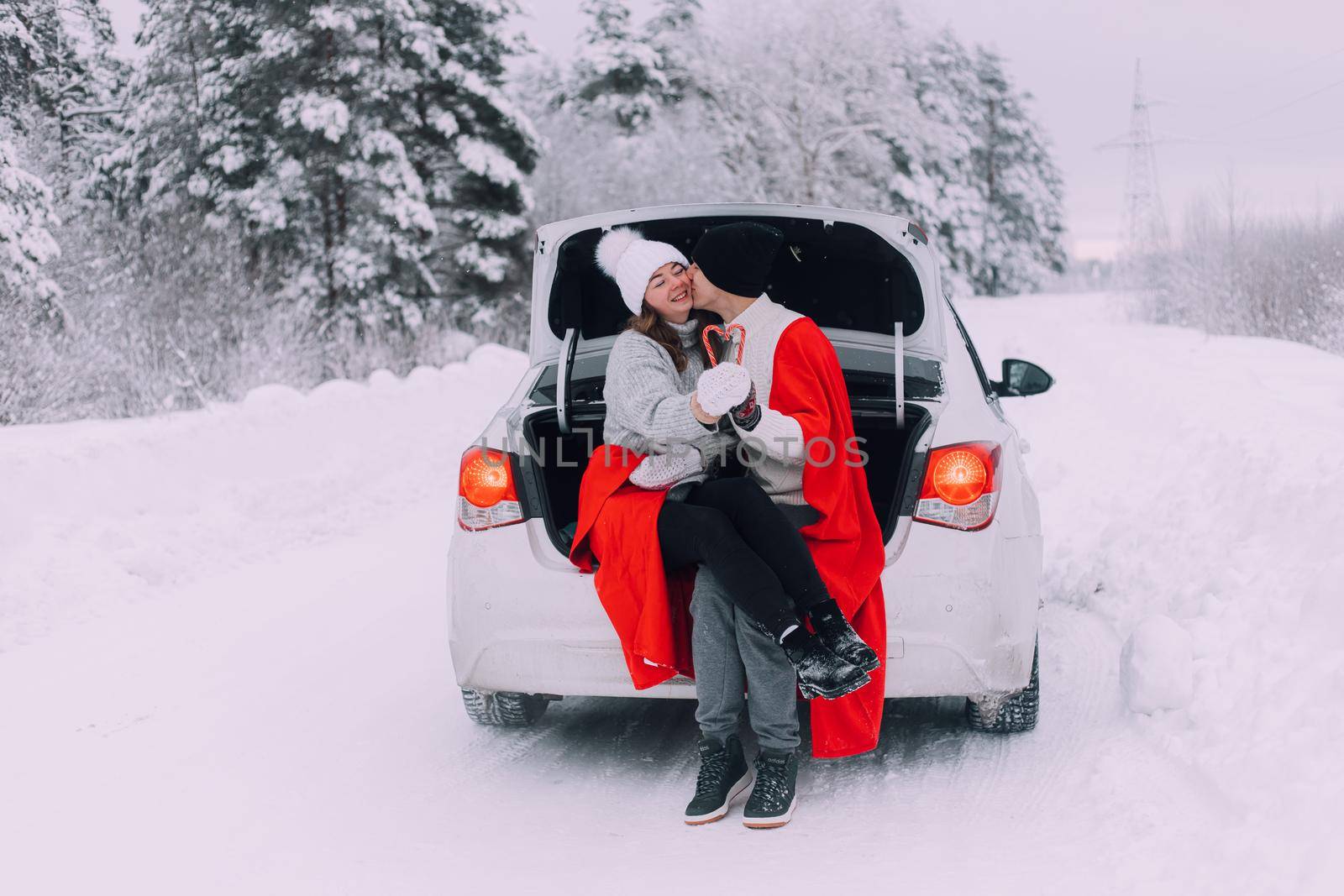 A couple in love in the trunk of a car lifestyle , An article about couples in love. An article about winter . Valentine's day. Love