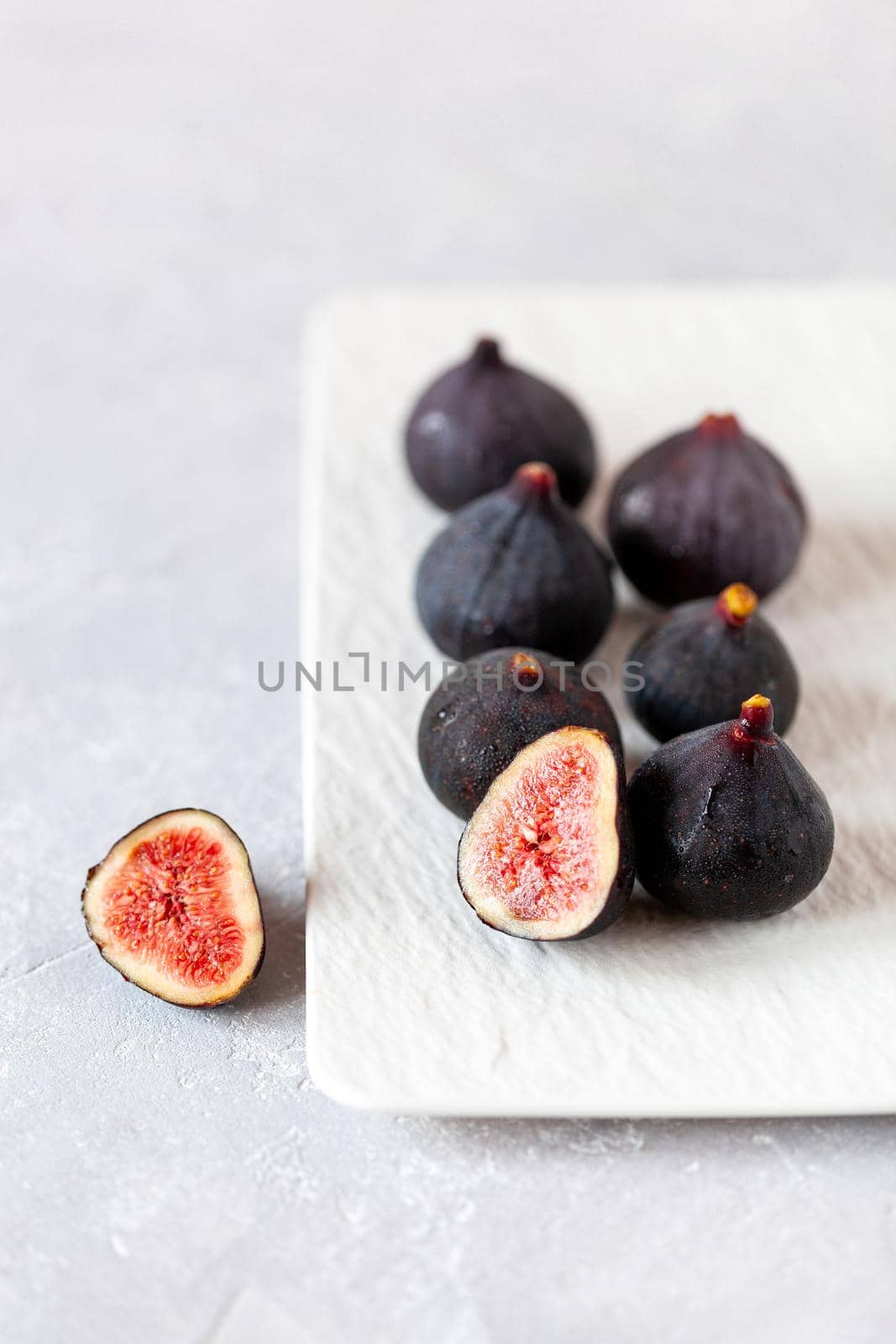 fresh ripe figs on a square plate, side view