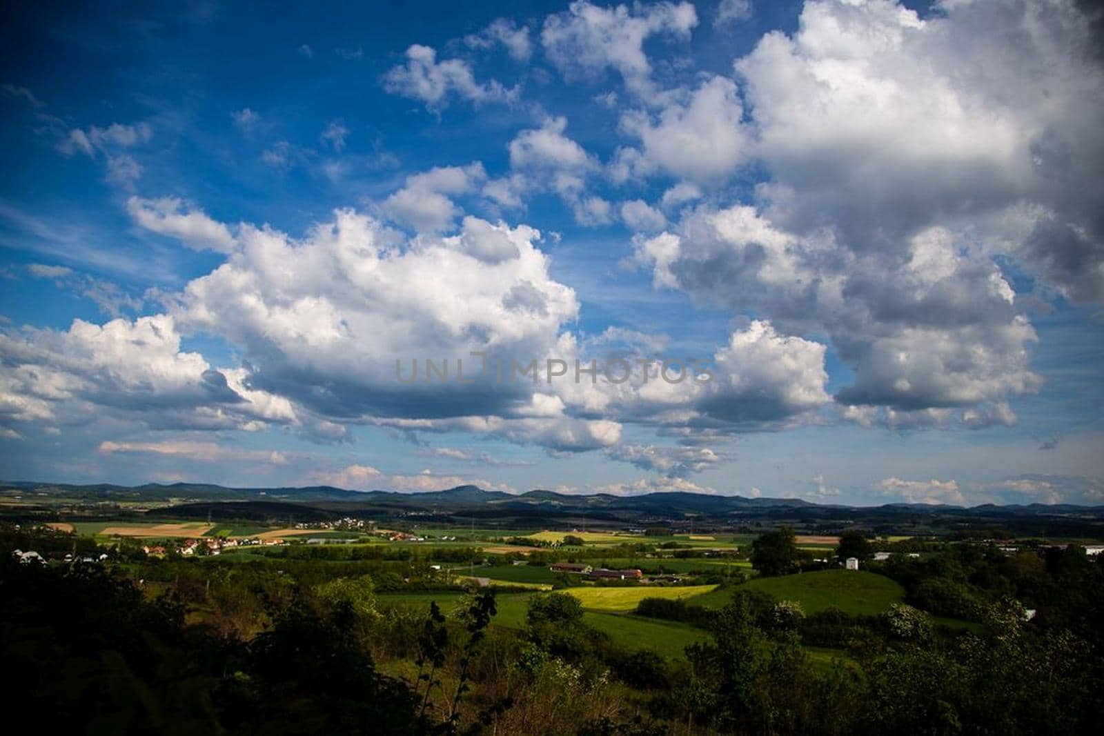 Beauty cloud against a blue sky background. Sky slouds. Blue sky with cloudy weather, nature cloud over the landskape. Over the land white clouds, blue sky and sun. High quality photo