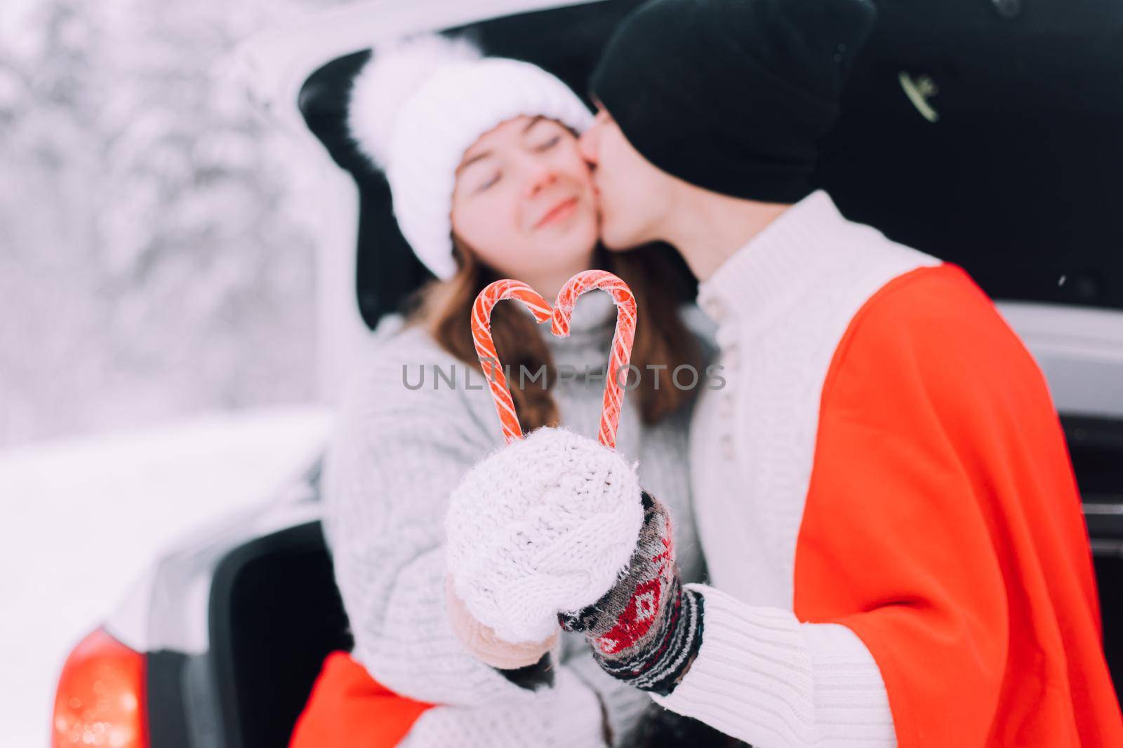 A couple in love in the trunk of a car lifestyle , An article about couples in love. An article about winter . Valentine's day. by alenka2194