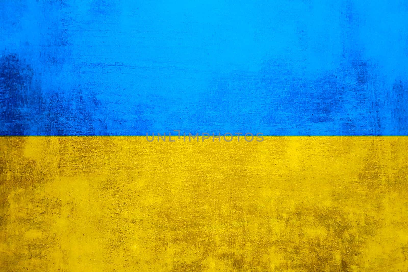 The wall is in the colors of the Ukrainian national flag - blue and yellow. Abstract texture background of concrete stone wall. Ukrainian flag on a grunge wall in connection with the war with Russia