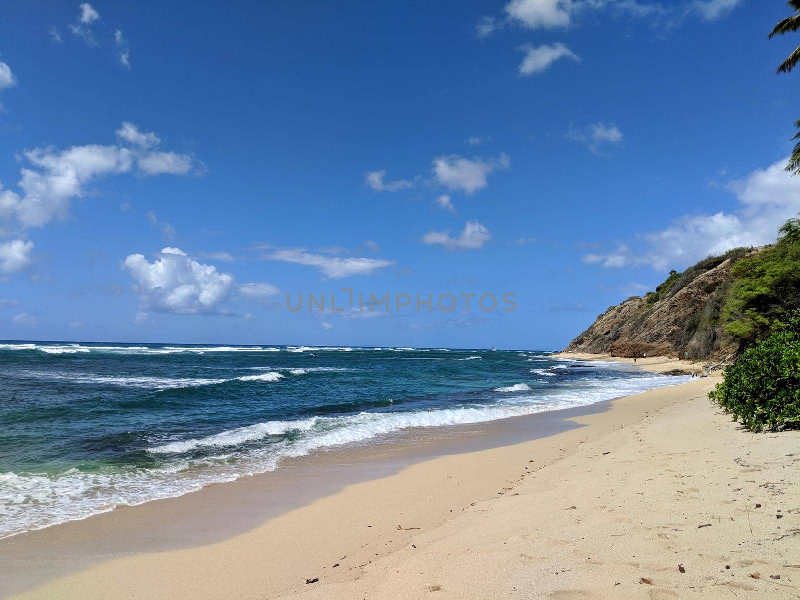 Waves lap on the sand on empty Diamond Head Beach on a Beautiful day by EricGBVD